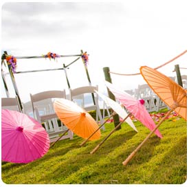 Colorful umbrellas and wedding chuppa provide shade at Weddings on Maui.