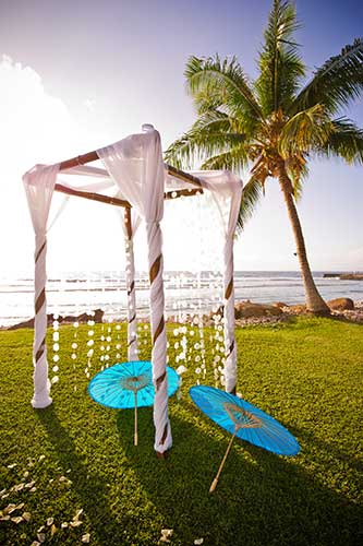 A linen draped bamboo chuppah wedding arch at Olowalu wedding in West Maui.