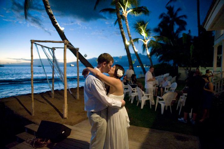 An image of a couple just married in Hawaii enjoying the first dance at a Maui beachfront wedding location.