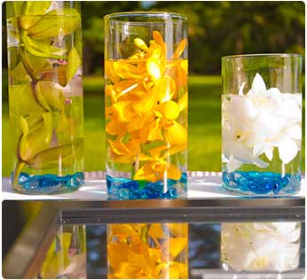 Fresh orchids floating in vases are affordable Maui wedding centerpieces.