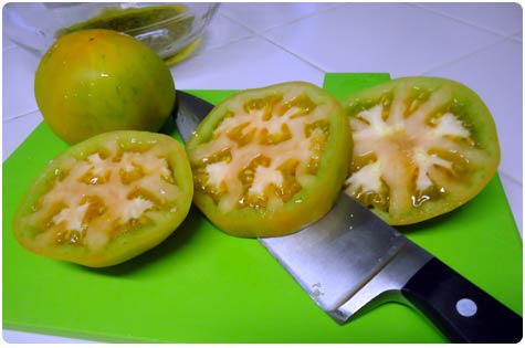 Green tomatoes sliced thick before marinating for fried green tomatoes recipe.