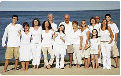 A casual Maui beach wedding with everyone wearin white for the family photograph.