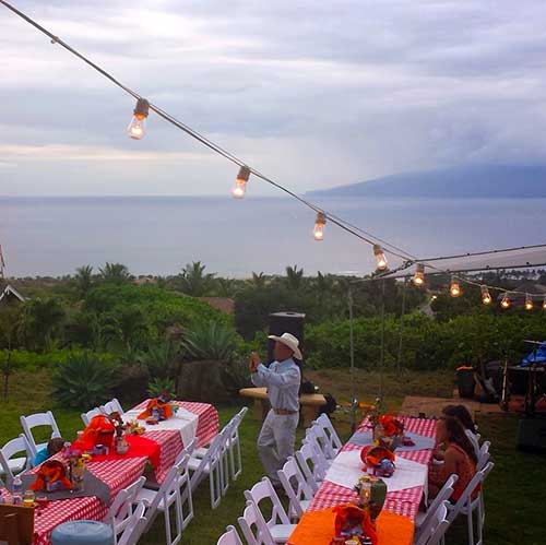 A catered farm to table dinner on Maui with a bbq theme served from wedding food stations