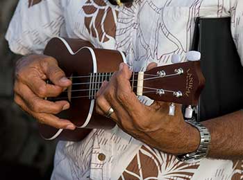 Maui wedding musician Pia Ululi plays ukulele while he performs at a Maui wedding ceremony.