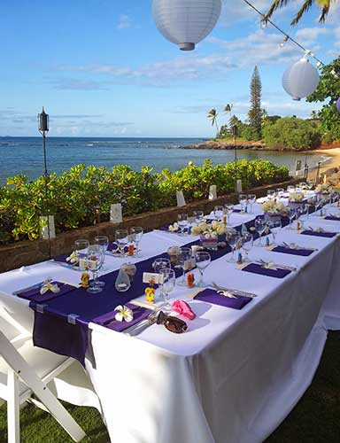 An ocean front Maui beach wedding reception table setup in Lahaina.