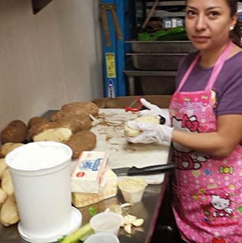 Iliana peeling potatoes at CJs Kaanapali restaurant on Maui.