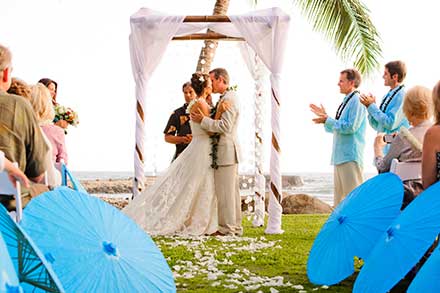 A Maui wedding at the Olowalu Plantation House with blue umbrellas and a bamboo chuppah.